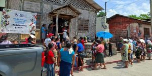 Familias rurales recibiendo raciones de alimentos por su participación en proyectos de desarrollo y mantenimiento comunitario.